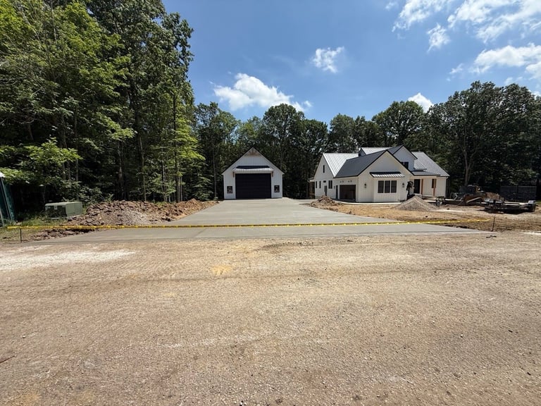 New construction home with attached garage and gravel driveway