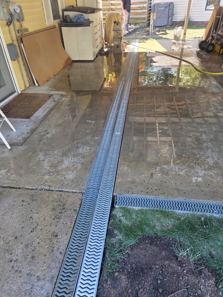 Garage interior with concrete floor and drainage channels