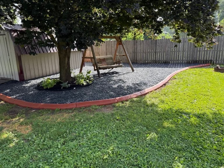 Backyard with green lawn, playset and landscaping