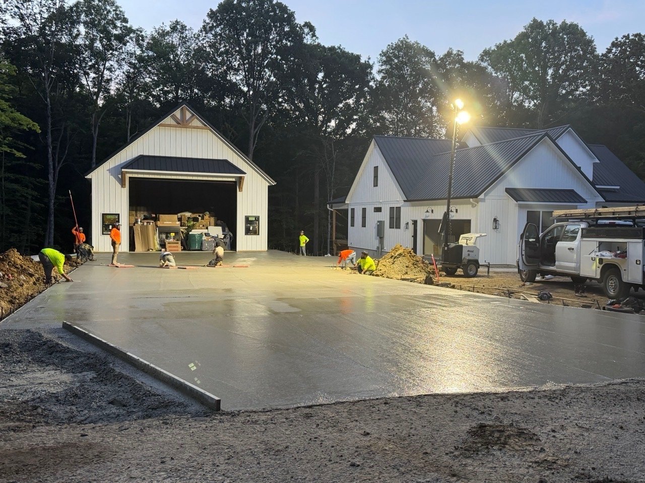 Freshly poured concrete driveway installation at night